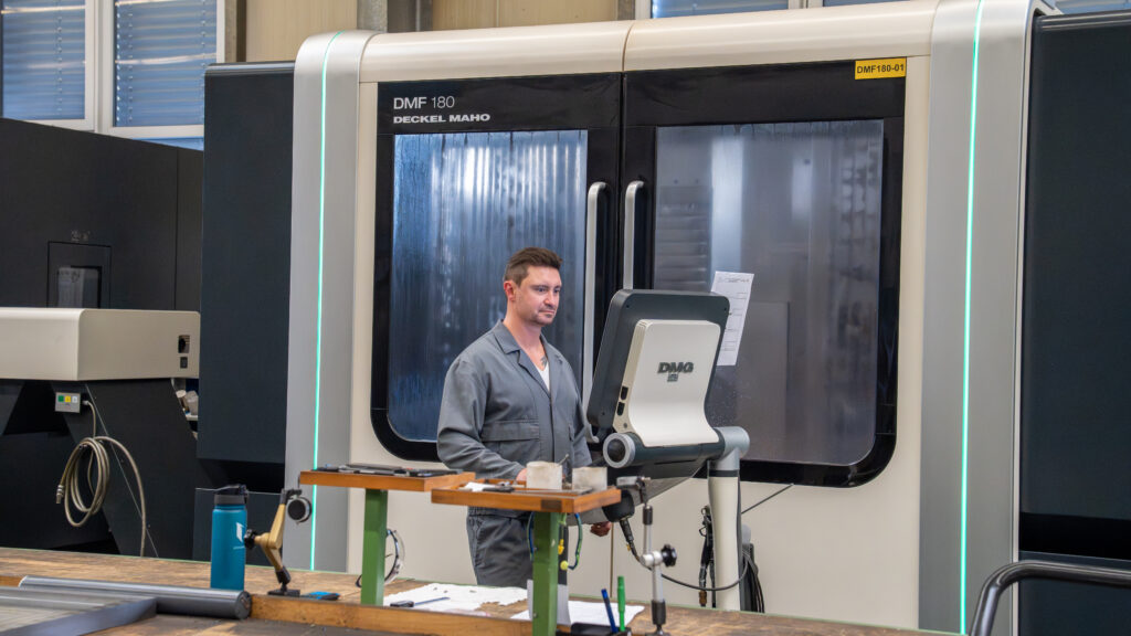 Employee working on a CNC milling machine